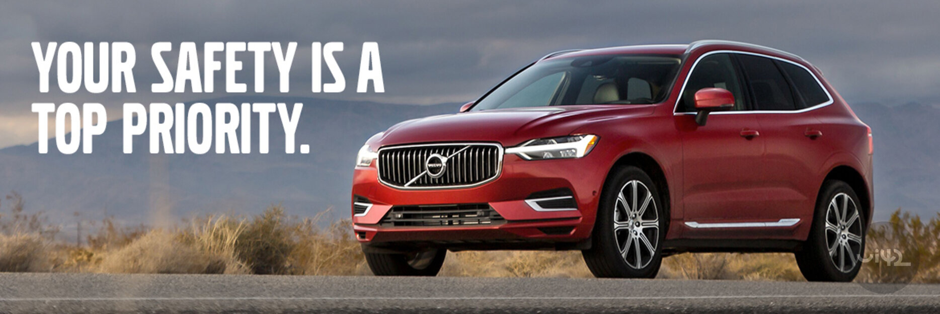 Červené SUV auto na cestě s textem 'YOUR SAFETY IS A TOP PRIORITY.'